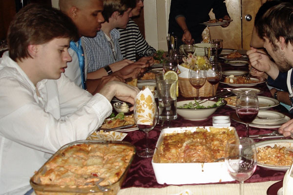 male students at dinner in dorm parents home