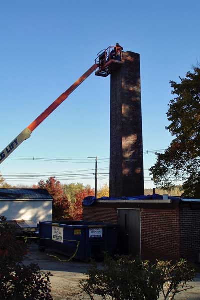 crane demolishing chimney