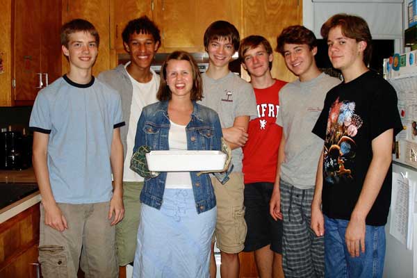 students in kitchen with dorm parent