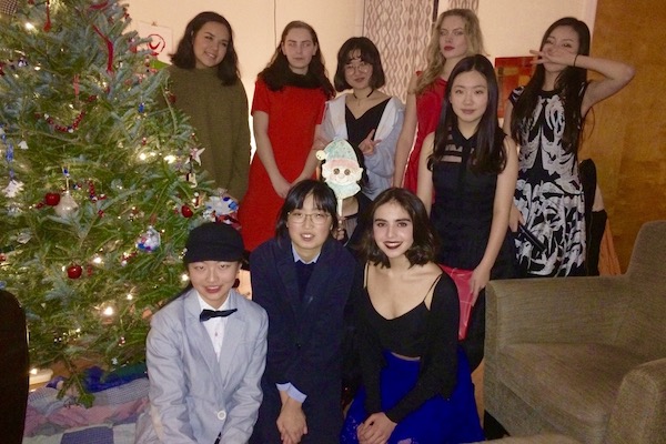 Students gathered by Christmas tree