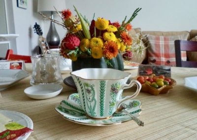 Flower arrangement and tea cup and saucer