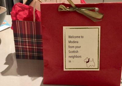 Red and tartan paper bags with welcome gifts