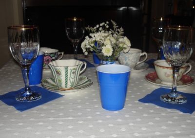 Blue paper cups and wine glasses