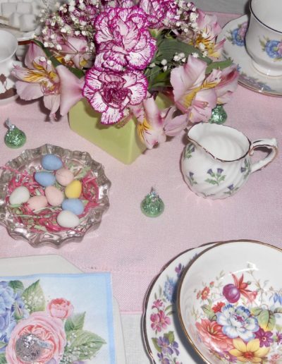 Flowers, chocolate eggs on table setting