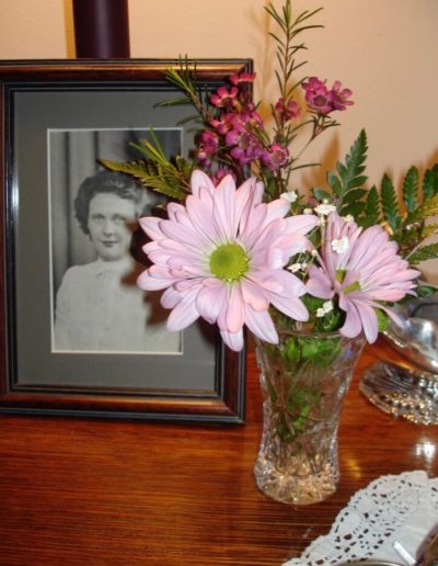 Flower arrangement and picture of woman
