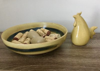 Pottery bowl with wine corks and egg shaped pebbles