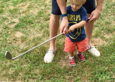small child with golf club