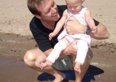 Man on beach with child
